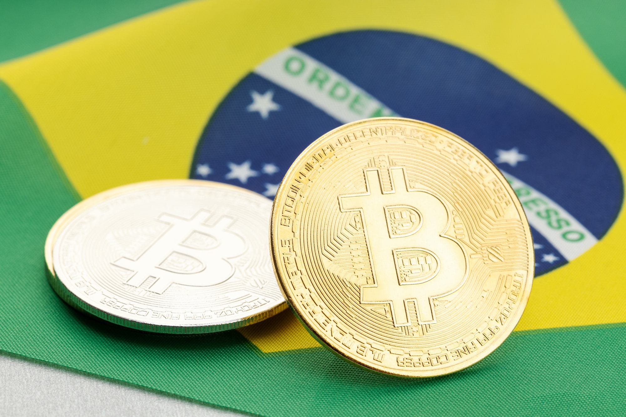 Bitcoin cryptocurrency coins on national flag of Brazil