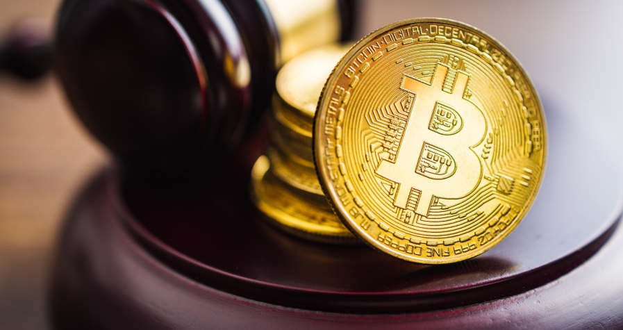 Cryptocurrency. Bitcoin virtual money. Golden coins and judge gavel.